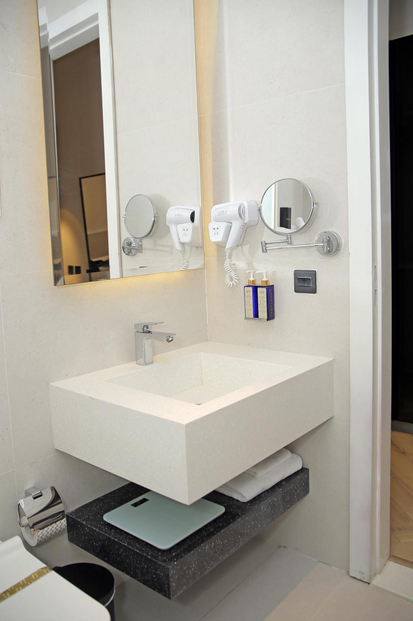 Ambiance Boutique Art Hotel Лахор Стая снимка A wall mounted hair dryer in a hotel bathroom